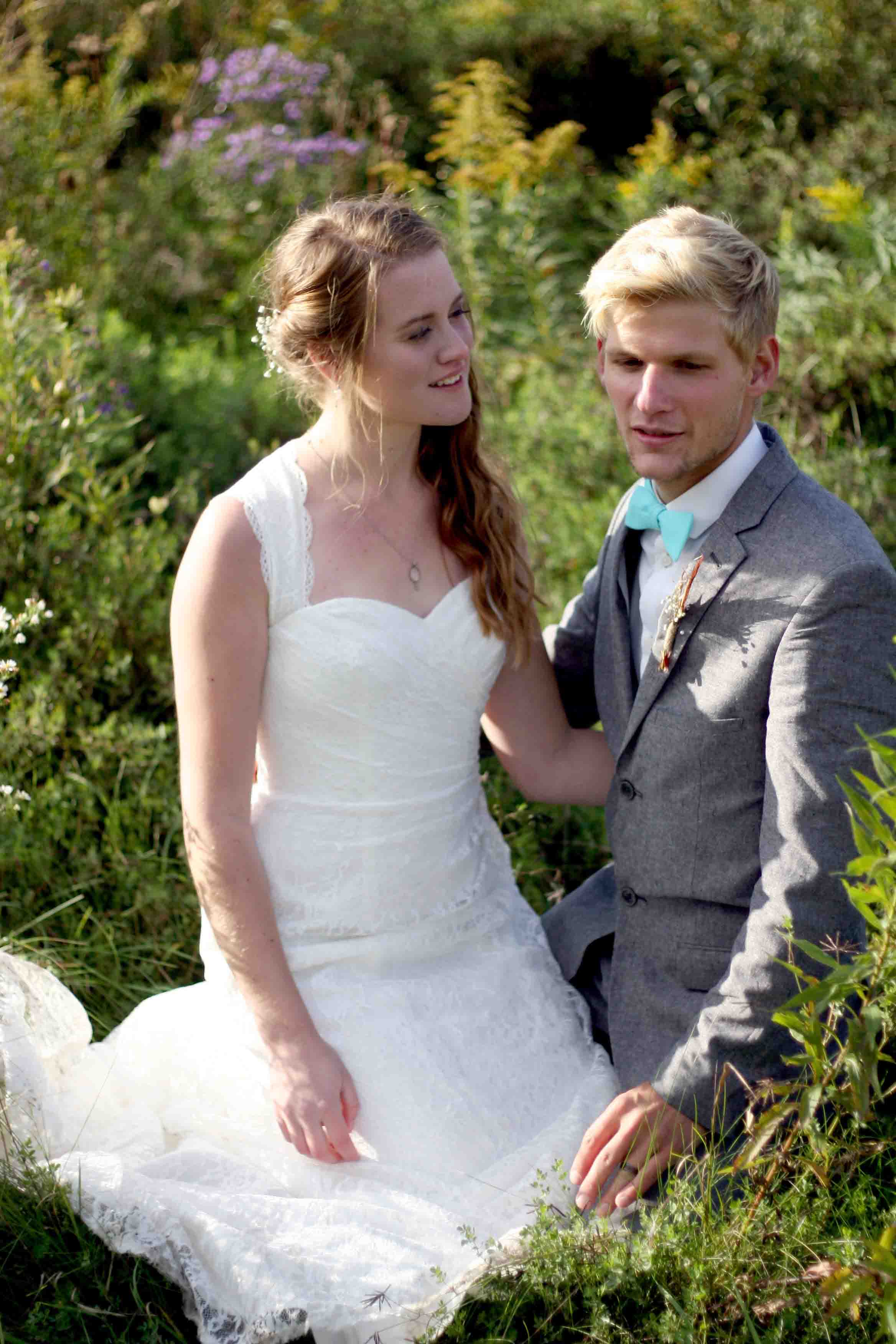 Greg and Karen kneeling in long grass